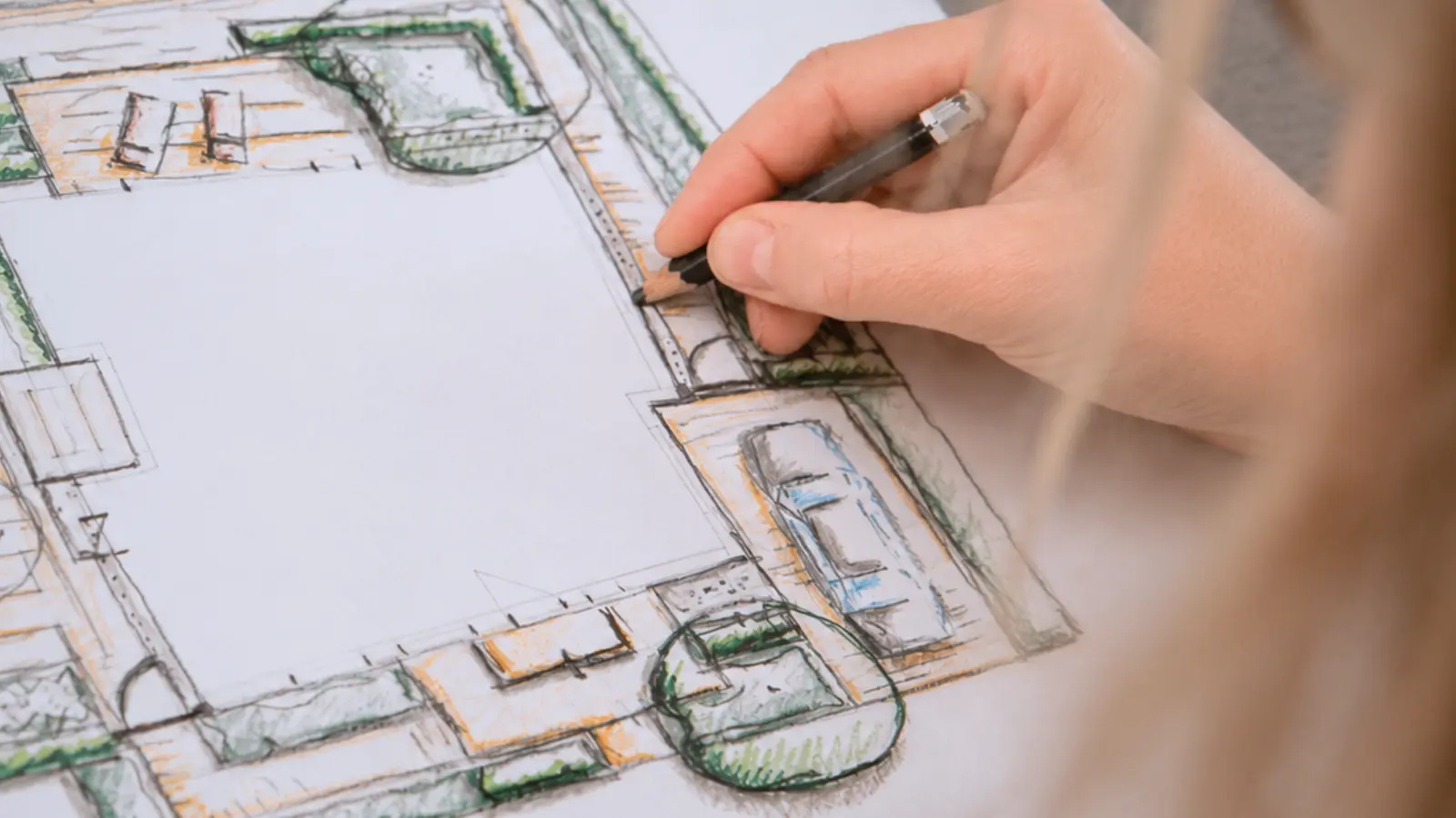 Hand sketching a garden layout with planting areas and landscape features, showing how site conditions can be translated into a practical and organized garden plan